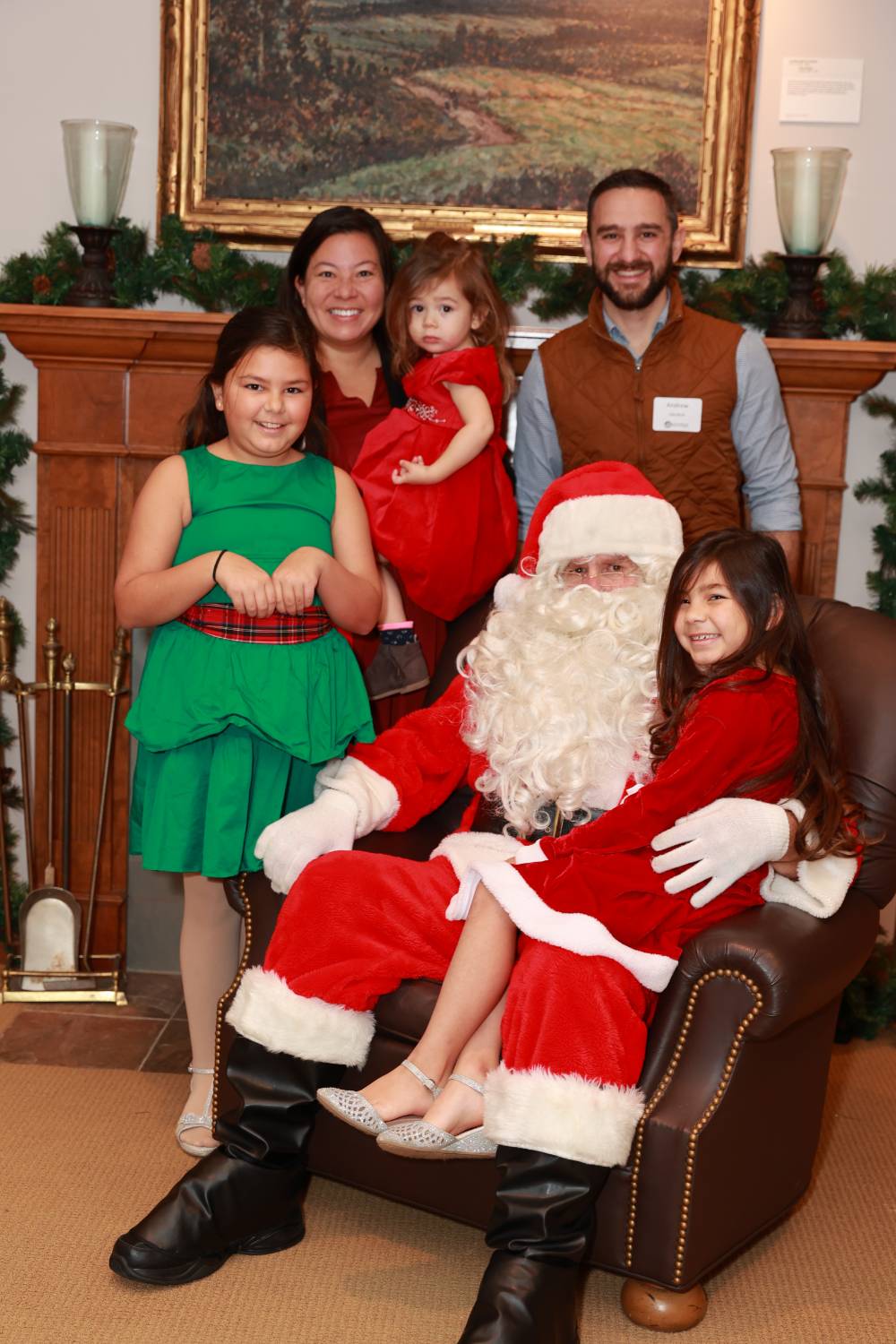 A family of five sitting with Santa.